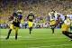 Sep 7, 2013; Ann Arbor, MI, USA; Michigan Wolverines wide receiver Jeremy Gallon (21) runs the ball into the end zone for a touchdown during the fourth quarter against the Notre Dame Fighting Irish at Michigan Stadium. Michigan Wolverines defeated Notre D