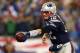 FOXBORO, MA - JANUARY 11: Tom Brady #12 of the New England Patriots hands off the ball against the Indianapolis Colts during the AFC Divisional Playoff game at Gillette Stadium on January 11, 2014 in Foxboro, Massachusetts. (Photo by Elsa/Getty Images)