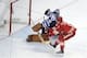 Jan 1, 2014; Ann Arbor, MI, USA; Toronto Maple Leafs goalie Jonathan Bernier (45) makes a save against Detroit Red Wings right wing Daniel Alfredsson (11) in the overtime shootout during the 2014 Winter Classic hockey game at Michigan Stadium. Mandatory C