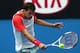MELBOURNE, AUSTRALIA - JANUARY 18: Grigor Dimitrov of Bulgaria plays a backhand in his third round match against Milos Raonic of Canada during day six of the 2014 Australian Open at Melbourne Park on January 18, 2014 in Melbourne, Australia. (Photo by R