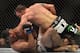 BRISBANE, AUSTRALIA - DECEMBER 07: Ryan Bader of the USA gets on top of Anthony Perosh of Australia during their UFC Fight Night Brisbane bout at the Brisbane Entertainment Centre on December 7, 2013 in Brisbane, Australia. (Photo by Bradley Kanaris/Get