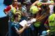 MELBOURNE, AUSTRALIA - JANUARY 18: Andy Murray of Great Britain signs autographs after winning his third round match against Feliciano Lopez of Spain during day six of the 2014 Australian Open at Melbourne Park on January 18, 2014 in Melbourne, Australia