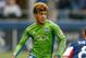 SEATTLE, WA - APRIL 13: DeAndre Yedlin #2 of the Seattle Sounders FC dribbles against Chris Tierney #8 of the New England Revolution at CenturyLink Field on April 13, 2013 in Seattle, Washington. (Photo by Otto Greule Jr/Getty Images)