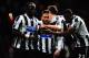 LONDON, ENGLAND - JANUARY 18: A team mate holds a bottle as Yohan Cabaye (C) of Newcastle United is congratulated by team mates after scoring his sides third goal during the Barclays Premier League match between West Ham United and Newcastle United at th