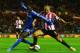 SUNDERLAND, ENGLAND - DECEMBER 17: Wes Brown of Sunderland and Demba Ba of Chelsea battle for the ball during the Capital One Cup Quarter-Final match between Sunderland and Chelsea at Stadium of Light on December 17, 2013 in Sunderland, England. (Photo