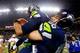 SEATTLE, WA - JANUARY 19: Quarterback Russell Wilson #3 is picked up by center Max Unger #60 of the Seattle Seahawks after the Seahawks defeated the San Francisco 49ers 23-17 during the 2014 NFC Championship at CenturyLink Field on January 19, 2014 in Se