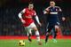 LONDON, ENGLAND - JANUARY 18: Mesut Ozil of Arsenal is challenged by Clint Dempsey of Fulham during the Barclays Premier League match between Arsenal and Fulham at Emirates Stadium on January 18, 2014 in London, England. (Photo by Clive Mason/Getty Imag