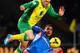 NORWICH, ENGLAND - JANUARY 18: Ahmed Elmohamady of Hull City tackles Gary Hooper of Norwich City during the Barclays Premier League match between Norwich City and Hull City at Carrow Road on January 18, 2014 in Norwich, England. (Photo by Christopher Le