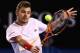MELBOURNE, AUSTRALIA - JANUARY 21: Stanislas Wawrinka of Switzerland plays a backhand in his quarterfinal match against Novak Djokovic of Serbia during the 2014 Australian Open at Melbourne Park on January 21, 2014 in Melbourne, Australia. (Photo by Mi