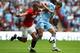 LONDON, ENGLAND - AUGUST 07: Nemanja Vidic of Manchester United and Edin Dzeko of Manchester City battle for the ball during the FA Community Shield match sponsored by McDonald's between Manchester City and Manchester United at Wembley Stadium on August