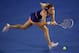 MELBOURNE, AUSTRALIA - JANUARY 20: Agnieszka Radwanska of Poland plays a backhand during her fourth round match against Garbine Muguruza of Spain during day eight of the 2014 Australian Open at Melbourne Park on January 20, 2014 in Melbourne, Australia.