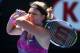 MELBOURNE, AUSTRALIA - JANUARY 20: Victoria Azarenka of Belarus plays a backhand in her fourth round match against Sloane Stephens of the United States during day eight of the 2014 Australian Open at Melbourne Park on January 20, 2014 in Melbourne, Austr
