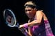 MELBOURNE, AUSTRALIA - JANUARY 20: Victoria Azarenka of Belarus plays a backhand in her fourth round match against Sloane Stephens of the United States during day eight of the 2014 Australian Open at Melbourne Park on January 20, 2014 in Melbourne, Austra