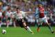 BIRMINGHAM, ENGLAND - AUGUST 24: Liverpool player Iago Aspas (l) beats Matthew Lowton to the ball during the Barclays Premier League match between Aston Villa and Liverpool at Villa Park on August 24, 2013 in Birmingham, England. (Photo by Stu Forster/G