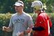 METAIRIE, LA - MAY 24: Quarterbacks coach Joe Lombardi of the New Orleans Saints works with Sean Canfield #4 during OTA's at the Saints Practice Facility on May 24, 2012 in Metairie, Louisiana. (Photo by Sean Gardner/Getty Images)
