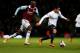 LONDON, ENGLAND - JANUARY 21: Marcos Mesquita Lopes of Manchester City is chased by Alou Diarra of West Ham United during the Capital One Cup Semi-Final, Second Leg match between West Ham United and Manchester City at Boleyn Ground on January 21, 2014 in