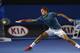 MELBOURNE, AUSTRALIA - JANUARY 20: Roger Federer of Switzerland stretches to play a forehand in his fourth round match against Jo-Wilfried Tsonga of France during day eight of the 2014 Australian Open at Melbourne Park on January 20, 2014 in Melbourne, A