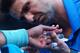 MELBOURNE, AUSTRALIA - JANUARY 22: A trainer treats the blister on the hand of Rafael Nadal of Spain in his quarterfinal match against Grigor Dimitrov of Bulgaria during day 10 of the 2014 Australian Open at Melbourne Park on January 22, 2014 in Melbourn