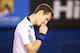 MELBOURNE, AUSTRALIA - JANUARY 22: Andy Murray of Great Britain reacts to a point in his quarterfinal match against Roger Federer of Switzerland during day 10 of the 2014 Australian Open at Melbourne Park on January 22, 2014 in Melbourne, Australia. (Ph