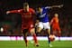 LIVERPOOL, ENGLAND - JANUARY 05: Korey Smith of Oldham takes on Lucas of Liverpool during the Budweiser FA Cup third round match between Liverpool and Oldham Athletic at Anfield on January 5, 2014 in Liverpool, England. (Photo by Clive Mason/Getty Image