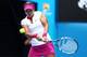 MELBOURNE, AUSTRALIA - JANUARY 21: Na Li of China plays a backhand in her quarterfinal match against Flavia Pennetta of Italy during day nine of the 2014 Australian Open at Melbourne Park on January 21, 2014 in Melbourne, Australia. (Photo by Renee McKa