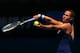 MELBOURNE, AUSTRALIA - JANUARY 22: Dominika Cibulkova of Slovakia serves in her quarterfinal match against Simona Halep of Romania during day 10 of the 2014 Australian Open at Melbourne Park on January 22, 2014 in Melbourne, Australia. (Photo by Quinn R