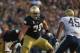 SOUTH BEND, IN - NOVEMBER 03: Zack Martin #70 of the Notre Dame Fighting Irish moves to block Shayne Hale #45 of the Pittsburgh Panthers at Notre Dame Stadium on November 3, 2012 in South Bend, Indiana. Notre Dame defeated Pittsburgh 29-26 in triple over