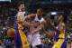 Jan 19, 2014; Toronto, Ontario, CAN; Toronto Raptors guard DeMar DeRozan (10) passes the ball in between Los Angeles Lakers forward Ryan Kelly (4) and forward-guard Nick Young (0) during the first half at the Air Canada Centre. Mandatory Credit: John E. S