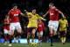 MANCHESTER, ENGLAND - DECEMBER 13: Samir Nasri of Arsenal competes with Darren Fletcher (R) and Michael Carrick of Manchester United during the Barclays Premier League match between Manchester United and Arsenal at Old Trafford on December 13, 2010 in Ma