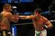 Jul 21, 2012; Calgary, AB, CANADA; Renan Barao (blue golves) and Urijah Faber (red gloves) during the interim bantamweight title bout of UFC 149 at the Scotiabank Saddledome. Mandatory Credit: Anne-Marie Sorvin-USA TODAY Sports
