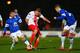 STEVENAGE, ENGLAND - JANUARY 25: Bryan Oviedo (L) of Everton injures himself challenging Simon Heslop of Stevenage watched by John Stones of Everton during the Budweiser FA Cup fourth round match between Stevenage and Everton at the Lamex Stadium on Janu