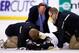 BOSTON, MA - DECEMBER 07: Brooks Orpik #44 of the Pittsburgh Penguins is tended to by the medical staff on the ice in the first period after an altercation with Shawn Thornton #22 of the Boston Bruins in the first period during the game at TD Garden on D