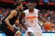 SYRACUSE, NY - JANUARY 04: Jerami Grant #3 of the Syracuse Orange drives to the basket around the defense of Donnavan Kirk #22 of the Miami Hurricanes during the second half at the Carrier Dome on January 4, 2014 in Syracuse, New York. Syracuse defeated