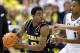 Jan 25, 2014; East Lansing, MI, USA; Michigan Wolverines guard Derrick Walton Jr. (10) looks to pass the ball against the Michigan State Spartans during the 2nd half of a game at Jack Breslin Student Events Center. Michigan won 80-75. Mandatory Credit: Mi