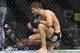 Jan 25, 2014; Chicago, IL, USA; Josh Thomson (blue gloves) reacts after losing to Benson Henderson (red gloves) during UFC on FOX 10 at the United Center. Mandatory Credit: David Banks-USA TODAY Sports