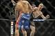 Jan 25, 2014; Chicago, IL, USA; Donald Cerrone (red gloves) kicks Adriano Martins (blue gloves) in the neck for a knock-out during UFC on FOX 10 at the United Center. Mandatory Credit: David Banks-USA TODAY Sports
