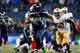 SEATTLE, WA - JANUARY 19: Running back Marshawn Lynch #24 of the Seattle Seahawks carries the ball against the San Francisco 49ers during the 2014 NFC Championship at CenturyLink Field on January 19, 2014 in Seattle, Washington. (Photo by Jonathan Ferre