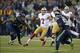 Jan 19, 2014; Seattle, WA, USA; San Francisco 49ers quarterback Colin Kaepernick (7) throws a touchdown pass in the third quarter pressured by Seattle Seahawks defensive end Michael Bennett (72) and linebacker Bruce Irvin (51) during the second half of th