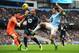 MANCHESTER, ENGLAND - NOVEMBER 24: Jesus Navas of Manchester City is closed down by goalkeeper Hugo Lloris and Younes Kaboul of Tottenham Hotspur during the Barclays Premier League match between Manchester City and Tottenham Hotspur at Etihad Stadium on