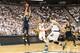 EAST LANSING, MI - JANUARY 25: Nik Stauskas #11 of the Michigan Wolverines shoots over Gary Harris #14 of the Michigan State Spartans during the first half of the game at the Breslin Center on January 25, 2014 in East Lansing, Michigan. The Wolverines de