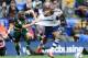 BOLTON, ENGLAND - AUGUST 24: David Ngog of Bolton Wanderers is pulled back by his shirt by Clint Hill of Queens Park Rangers during the Sky Bet Championship match between Bolton Wanderers and Queens Park Rangers at Reebok Stadium on August 24, 2013 in Bo