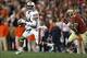 Jan 6, 2014; Pasadena, CA, USA; Auburn Tigers quarterback Nick Marshall (14) looks to throw as he is chased by Florida State Seminoles linebacker Christian Jones (7) during the first half of the 2014 BCS National Championship game at the Rose Bowl. Manda