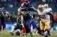 SEATTLE, WA - JANUARY 19: Running back Marshawn Lynch #24 of the Seattle Seahawks carries the ball against the San Francisco 49ers during the 2014 NFC Championship at CenturyLink Field on January 19, 2014 in Seattle, Washington. (Photo by Jonathan Ferre