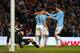 MANCHESTER, ENGLAND - JANUARY 18: Sergio Aguero of Manchester City celebrates with teammates Jesus Navas (L) and Edin Dzeko (R) after scoring his team's fourth goal during the Barclays Premier League match between Manchester City and Cardiff City at the