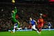 LIVERPOOL, ENGLAND - JANUARY 28: Daniel Sturridge of Liverpool chips the ball over goalkeeper Tim Howard of Everton to score his team's third goal during the Barclays Premier League match between Liverpool and Everton at Anfield on January 28, 2014 in Li