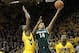 Jan 28, 2014; Iowa City, IA, USA; Iowa Hawkeyes forward Gabriel Olaseni (0) defends Michigan State Spartans guard Gary Harris (14) during the first half at Carver-Hawkeye Arena. Mandatory Credit: Reese Strickland-USA TODAY Sports