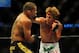 Jul 21, 2012; Calgary, AB, CANADA; Renan Barao (blue golves) and Urijah Faber (red gloves) during the interim bantamweight title bout of UFC 149 at the Scotiabank Saddledome. Mandatory Credit: Anne-Marie Sorvin-USA TODAY Sports