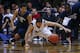 INDIANAPOLIS, IN - DECEMBER 31: Josh Hart #3 and JayVaughn Pinkston #22 of the Villanova Wildcats watch as Kellen Dunham #24 of the Butler Bulldogs dives for a loose ball at Hinkle Fieldhouse on December 31, 2013 in Indianapolis, Indiana. Villanova defeat