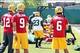 May 22, 2012; Green Bay, WI, USA; Green Bay Packers quarterbacks Aaron Rodgers (12) , B.J. Coleman (9) and Graham Harrell (6) wait to run through a drill during organized team activities at Ray Nitschke Field. Mandatory Credit: Mary Langenfeld-USA TODAY S