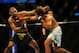 Jul 21, 2012; Calgary, AB, CANADA; Renan Barao (blue golves) and Urijah Faber (red gloves) during the interim bantamweight title bout of UFC 149 at the Scotiabank Saddledome. Mandatory Credit: Anne-Marie Sorvin-USA TODAY Sports